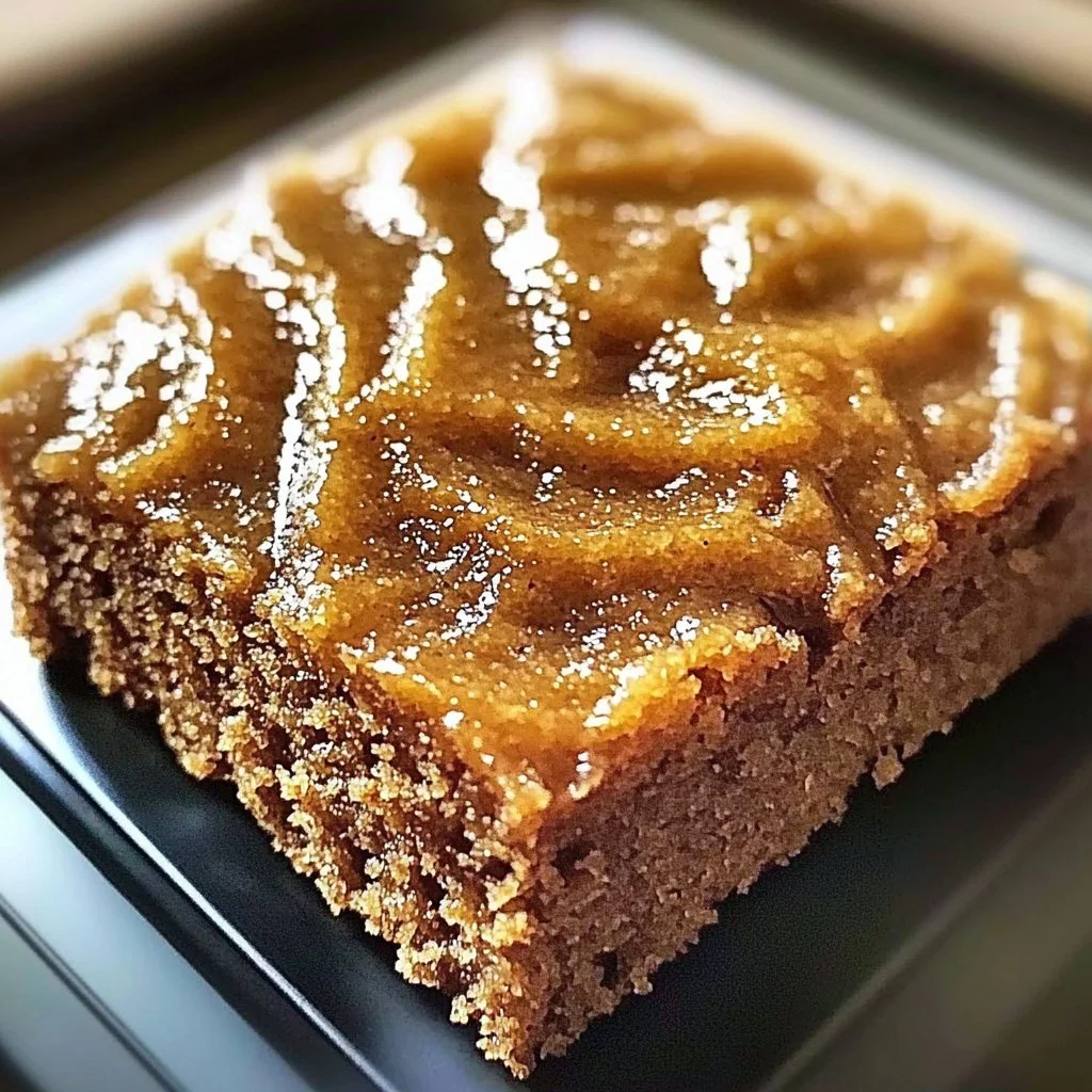 Slice of moist Amish Applesauce Cake on a rustic wooden table