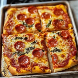 Homemade sheet pan pizza topped with fresh ingredients and sliced ready to serve.