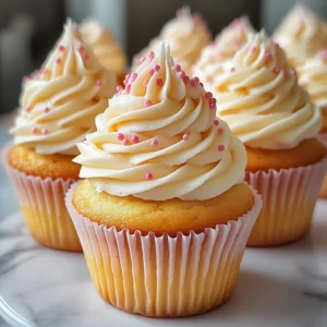 Vanilla cupcakes topped with rich buttercream frosting on a decorative platter.