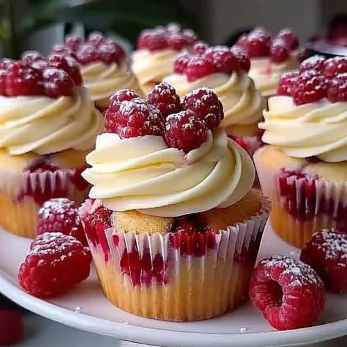 Almond Wedding Cake Cupcakes filled with raspberry and topped with frosting