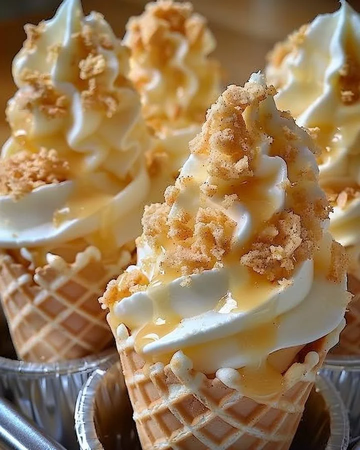 Banana pudding cheesecake cones topped with whipped cream and slices of banana