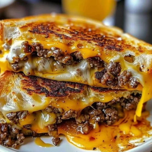 Delicious beef grilled cheese sandwich with melted cheese and juicy beef