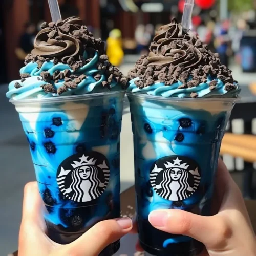 Blue Cookies & Cream Dip Frappuccino topped with whipped cream and cookie crumbles