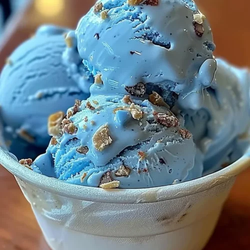 A scoop of Blue Moon ice cream in a cone, showcasing its vibrant blue color.