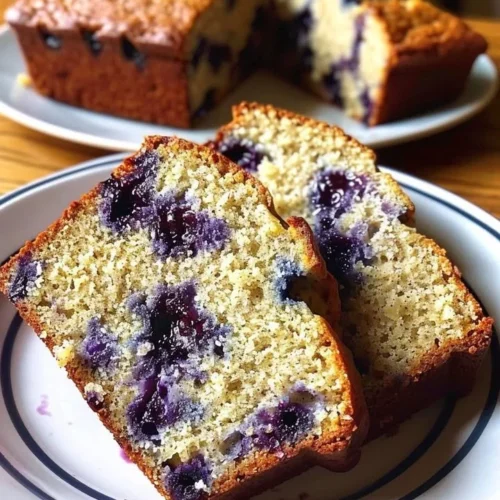Loaf of homemade blueberry banana bread with fresh blueberries
