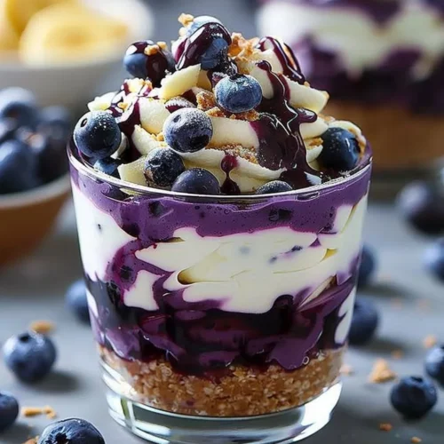 Delicious blueberry cheesecake parfait with layers of cream and fresh blueberries