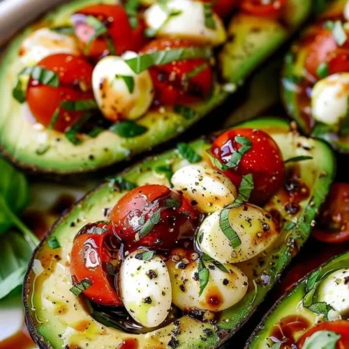 Delicious Caprese stuffed avocado with mozzarella and tomatoes