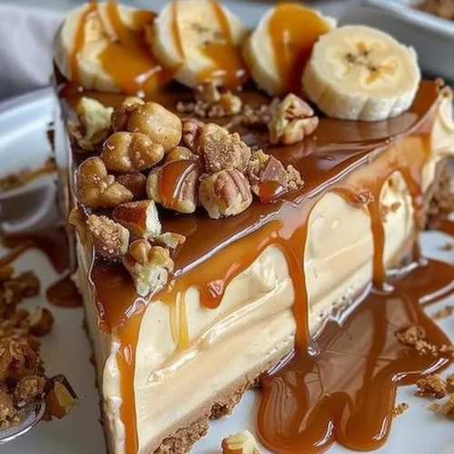 Delicious Caramel Banana Crunch Cheesecake with banana slices and caramel drizzle