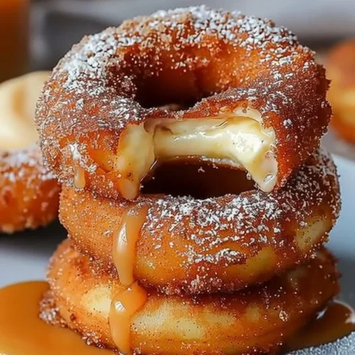 Caramel cheesecake-stuffed churro rings drizzled with caramel sauce.