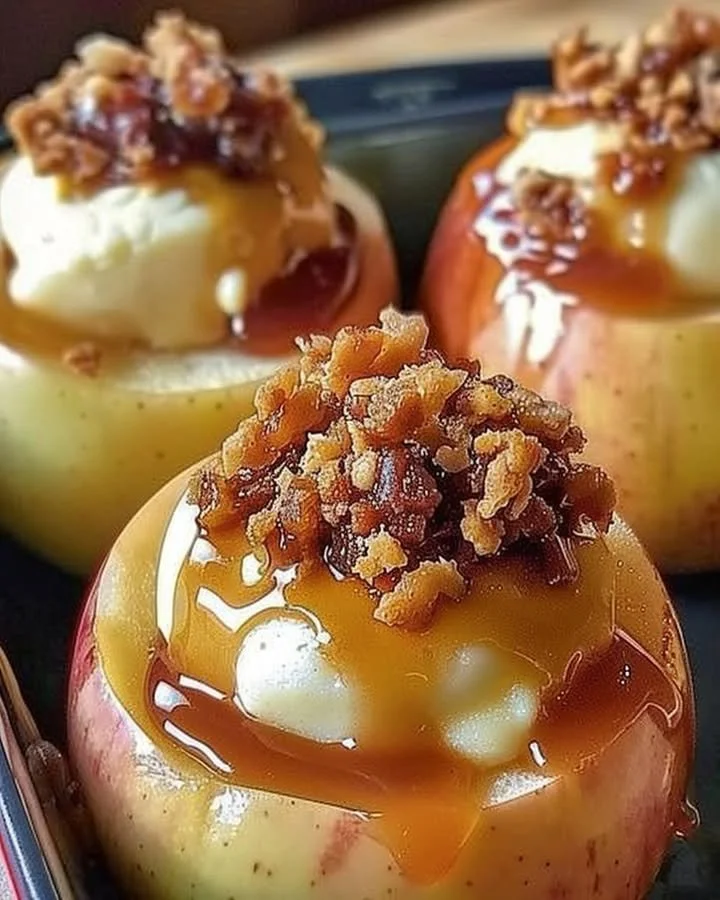 Baked apples filled with creamy cheesecake filling, dessert idea.