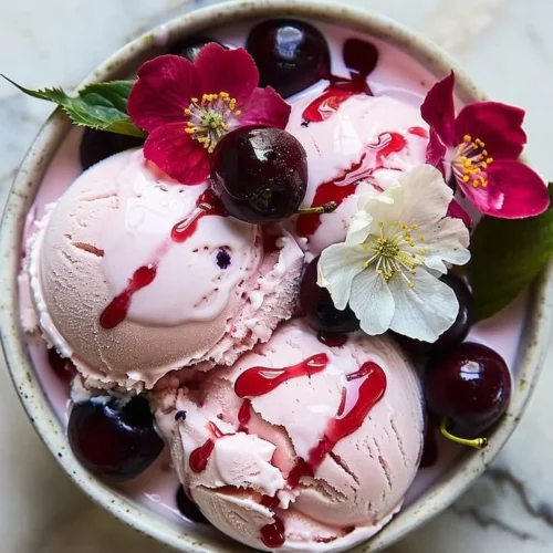 Delicious Cherry Blossom Ice Cream in a decorative bowl topped with pink blossoms.