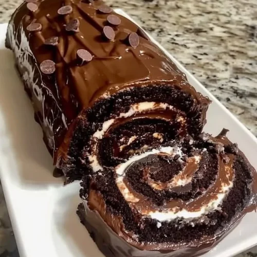 Delicious chocolate cake roll with creamy filling and decorative chocolate shavings