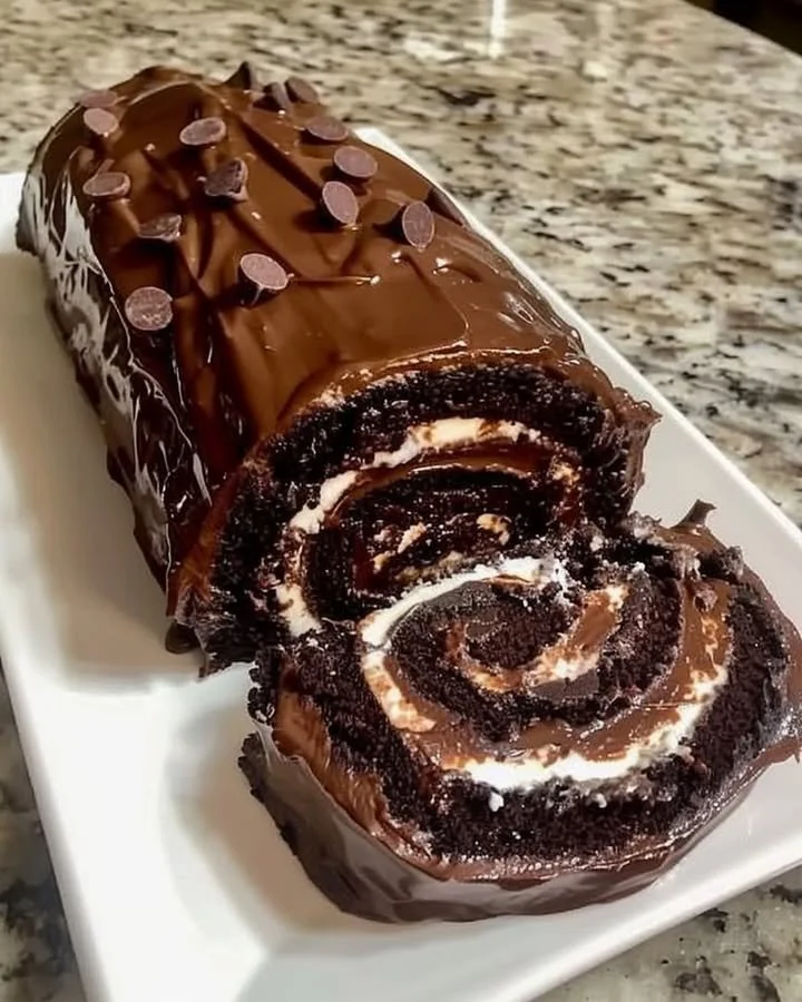 Delicious chocolate cake roll with creamy filling and decorative chocolate shavings