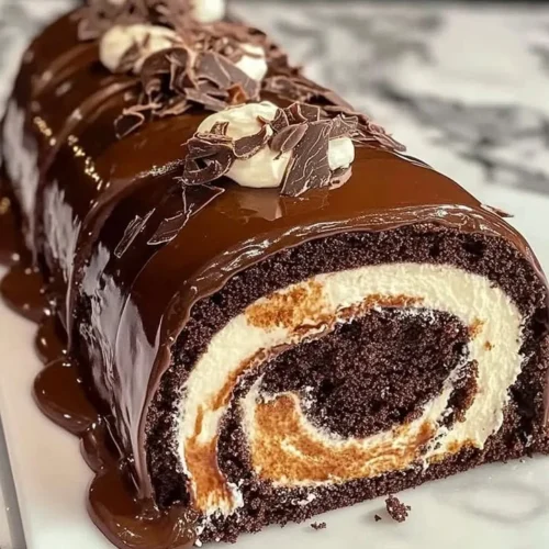 Delicious Chocolate Cake Roll with cream filling on a white plate