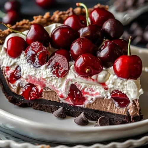 Delicious Chocolate Cherry Cream Pie topped with fresh cherries and whipped cream