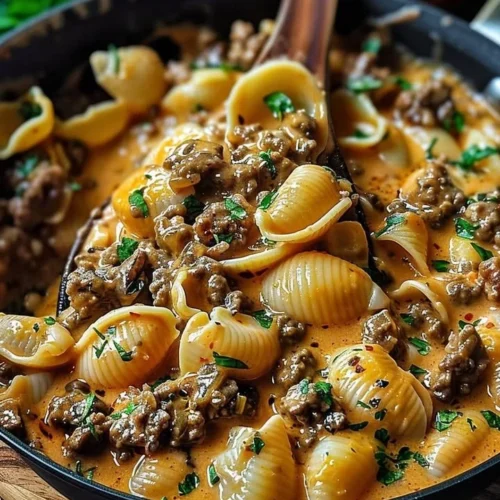 Creamy Beef Shells Casserole with cheese and herbs ready to serve