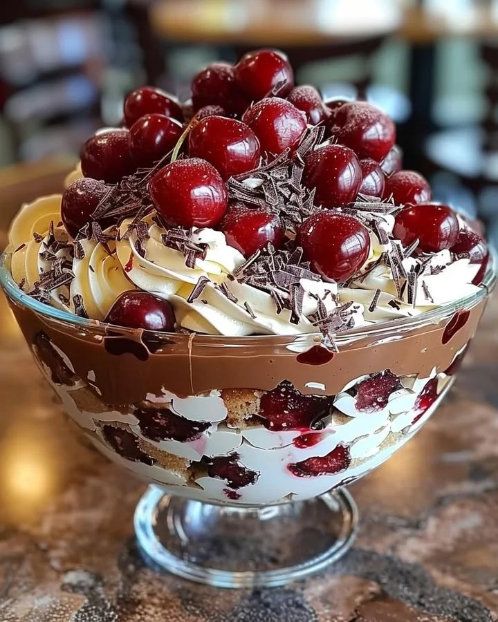 Delicious cherry chocolate trifle layered with cherries and chocolate cream.