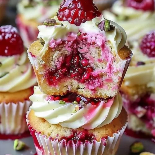 Fluffy raspberry pistachio cupcakes with vibrant pink frosting