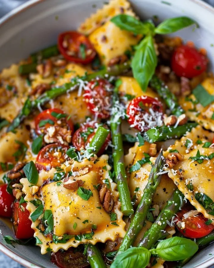 Delicious garden fresh asparagus and tomato ravioli served in a light sauce.