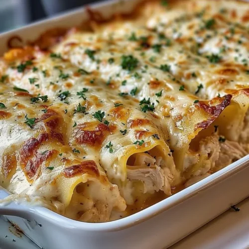 Delicious Garlic Parmesan Chicken Lasagna Roll-Ups topped with cheese