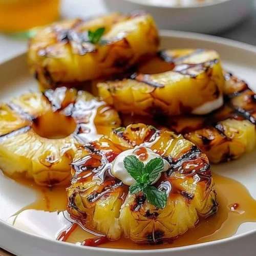 Delicious grilled pineapple slices on a barbecue grill.