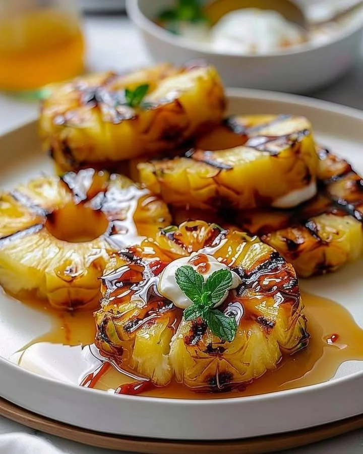 Delicious grilled pineapple slices on a barbecue grill.