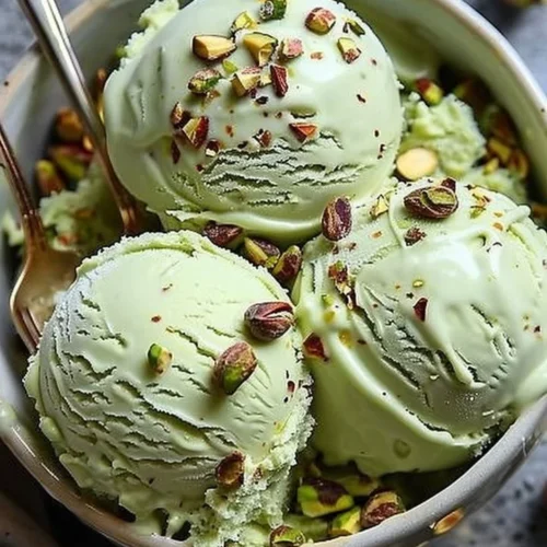 High protein pistachio ice cream served in a bowl with pistachios on top
