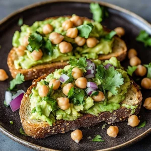 High protein vegan avocado toast topped with fresh vegetables and seeds.