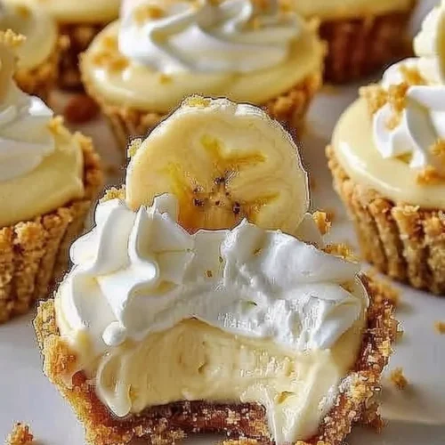 Delicious no-bake mini banana cream pies garnished with whipped cream and banana slices