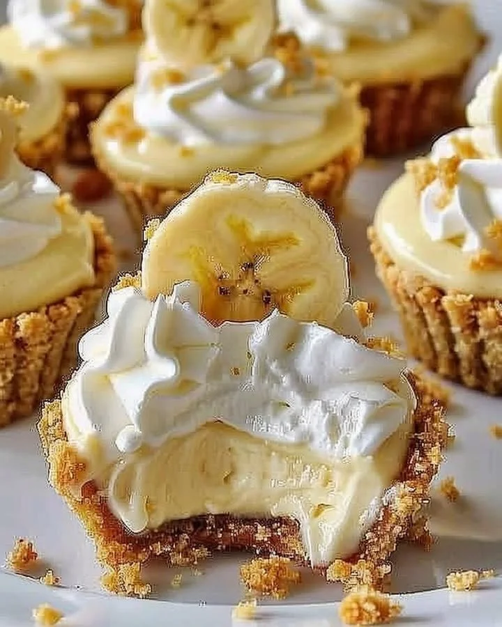 Delicious no-bake mini banana cream pies garnished with whipped cream and banana slices