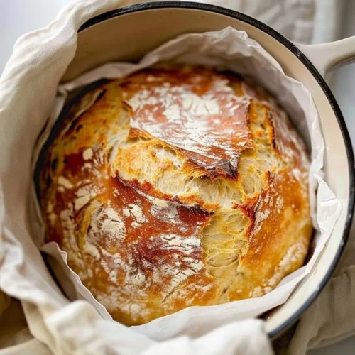 Freshly baked No Knead Artisan Bread on a wooden cutting board