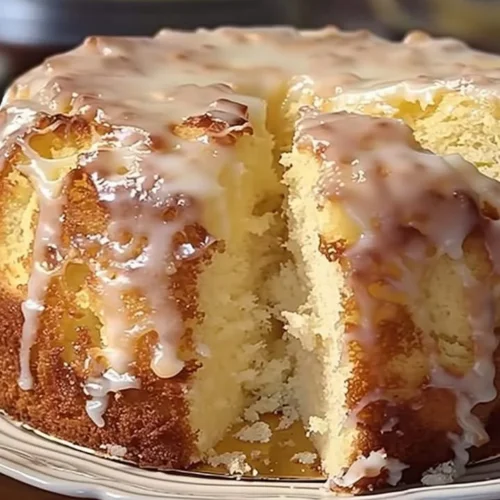 Slice of Pina Colada Pound Cake with coconut and pineapple garnish