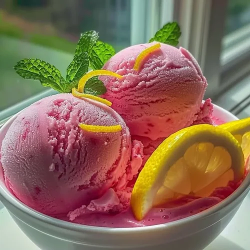 Delicious Pink Lemonade Sorbet served in a bowl with fresh lemon slices