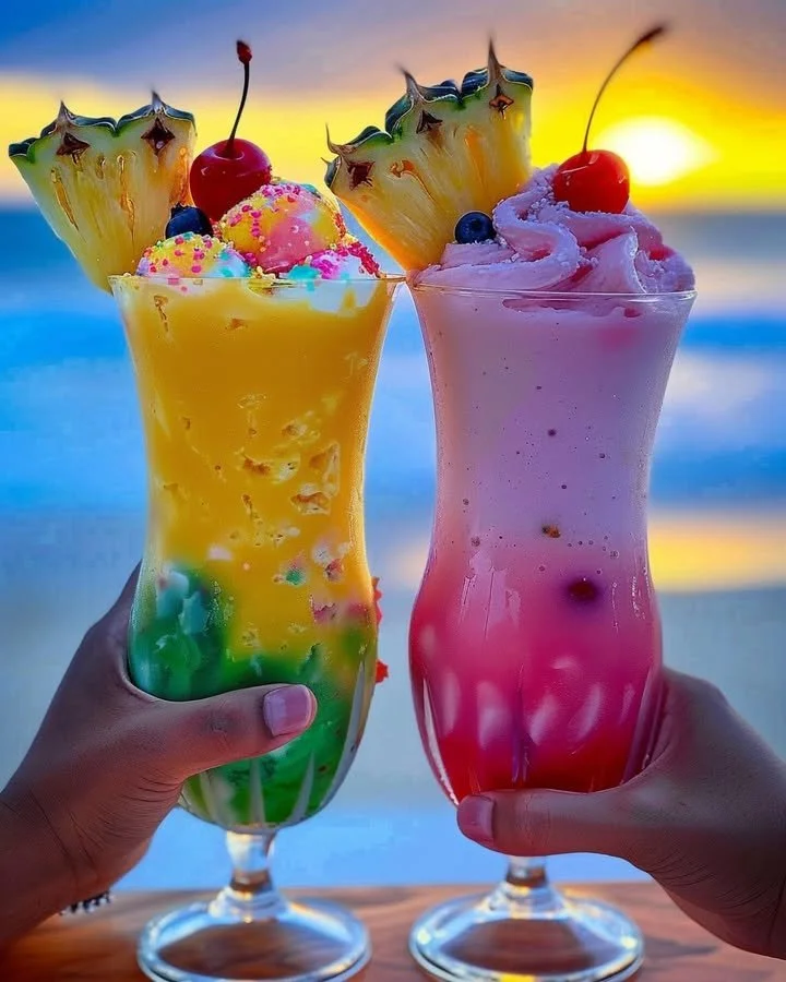 Delicious Rainbow Sherbet Piña Colada drink topped with vibrant colors