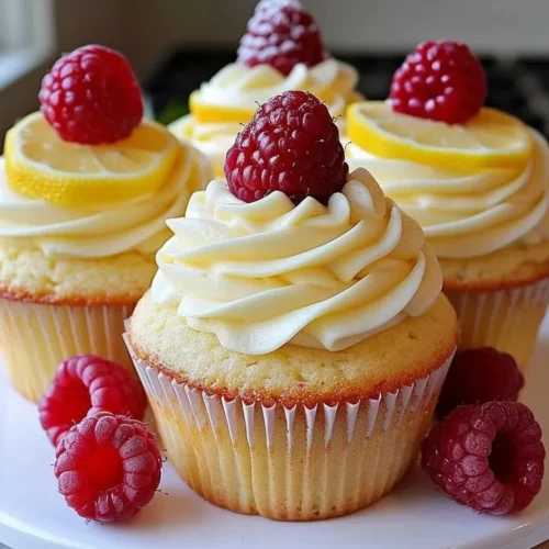Delicious Raspberry Lemon Cupcakes topped with frosting and fresh raspberries