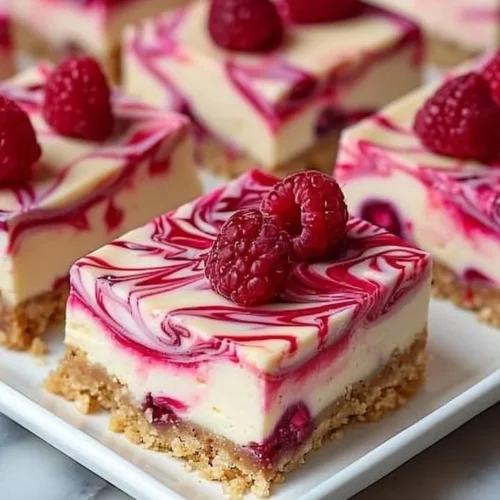 Delicious raspberry swirl cheesecake bars on a plate