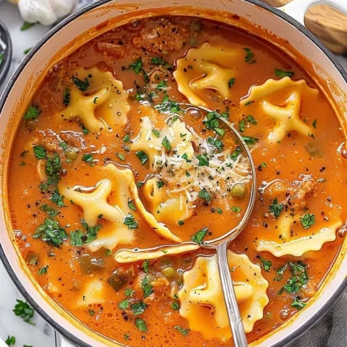 Delicious one-pot ravioli soup served in a bowl with fresh herbs