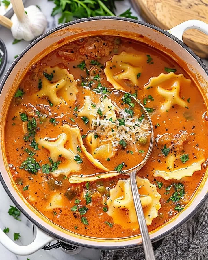 Delicious one-pot ravioli soup served in a bowl with fresh herbs