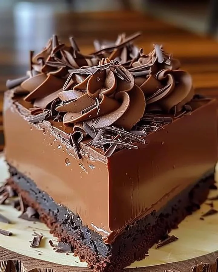 Rich chocolate mousse cake topped with chocolate shavings and fresh berries
