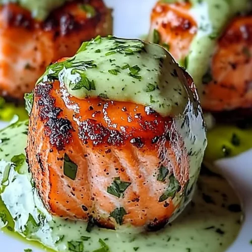 Delicious salmon balls served with creamy avocado sauce on a plate.