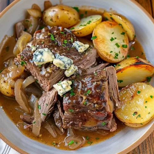Savory chuck roast served with blue cheese gravy on a plate
