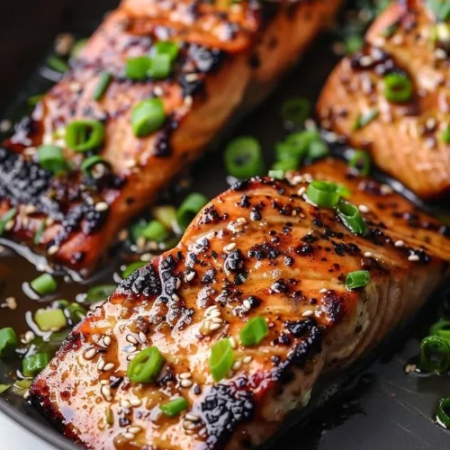 Silken miso-ginger glazed salmon served with vegetables on a plate