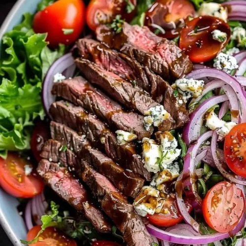 Sliced steak salad with gorgonzola cheese and fresh greens