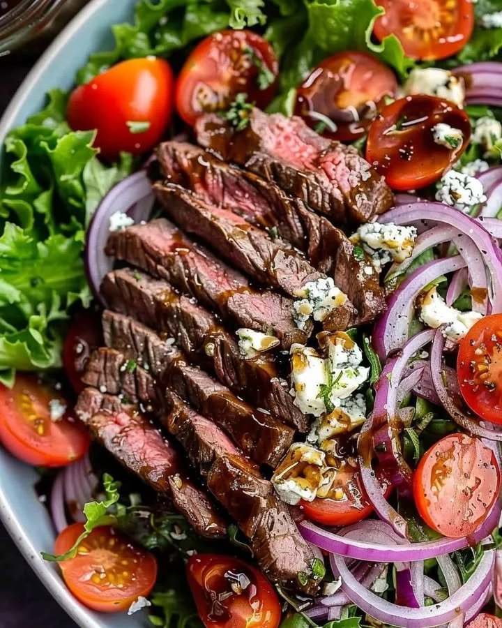 Sliced steak salad with gorgonzola cheese and fresh greens