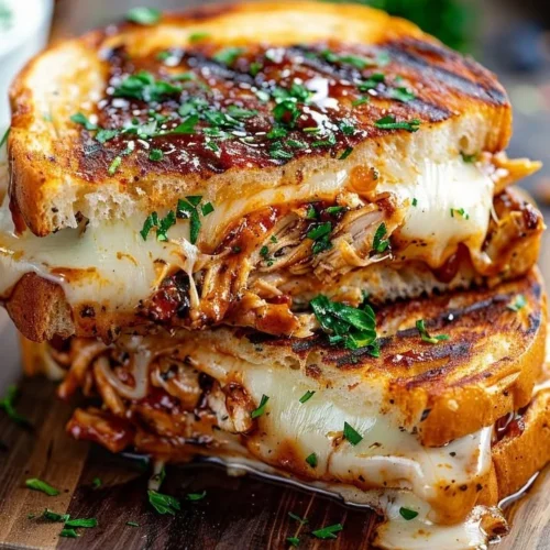 Smoky BBQ chicken served on a plate, showcasing juicy texture and rich sauce.