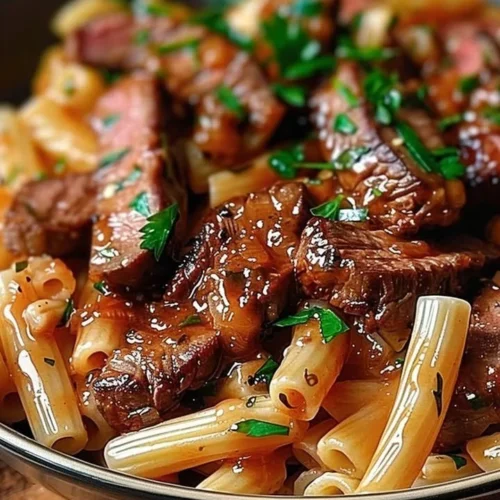 Spicy Honey BBQ Steak Pasta served in a bowl with vibrant vegetables