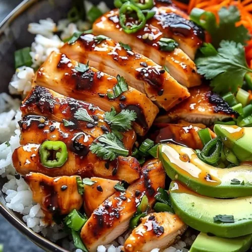 Spicy Honey Ginger Chicken Bowl with vegetables and rice in a vibrant dish