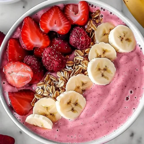 Healthy strawberry banana smoothie in a glass with fresh fruits