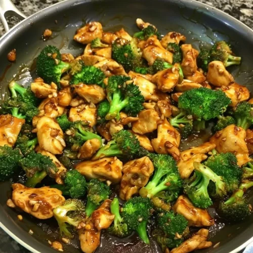 Szechuan-Style Chicken with Broccoli dish garnished with herbs