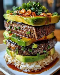 Teriyaki Beef and Avocado Rice Stack with fresh ingredients